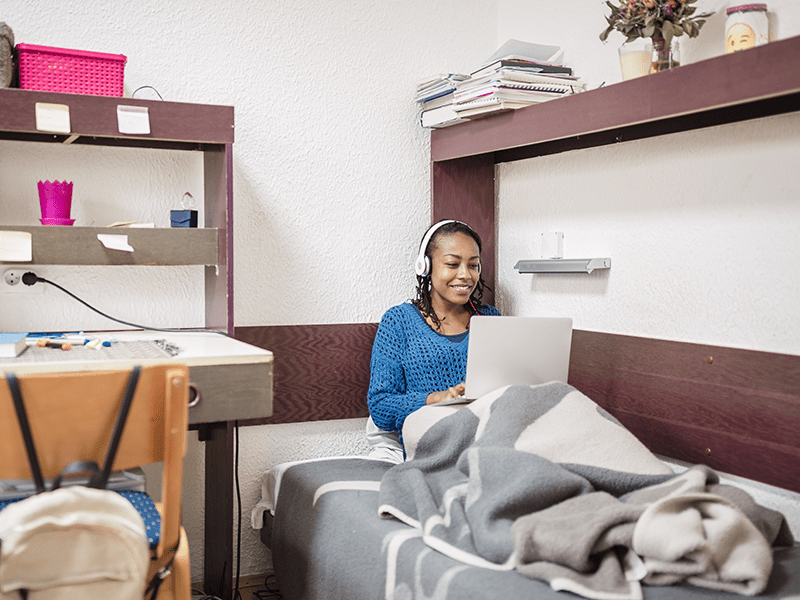 Resident using a laptop in a residential room